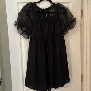 Black dress with mesh puff sleeves.